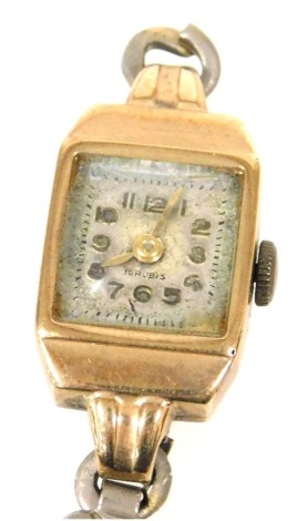 A mid century lady's 9ct gold cased wristwatch, square dial bearing Arabic numerals, fifteen jewelled movement, the case of plain form, on a base metal strap.