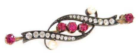 A Victorian ruby, diamond and seed pearl brooch, in a scrolling design, in white and yellow metal, 4.2g all in.