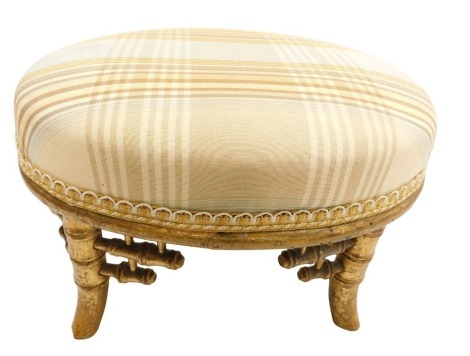 A Victorian gilt wood footstool, in the Japanese taste, with an overstuffed striped seat, raised on four faux bamboo outswept legs, 34cm wide.