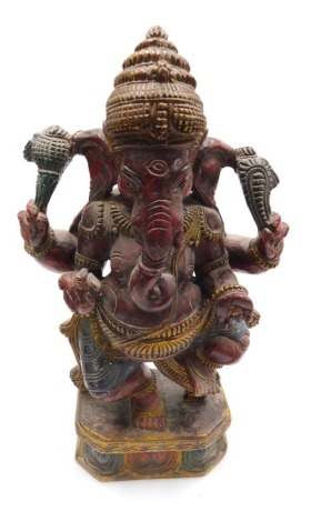 An early 20thC Indian polychrome wooden figure of Gnesh, lord of good fortune, raised on a lotus flower base, 45cm high.