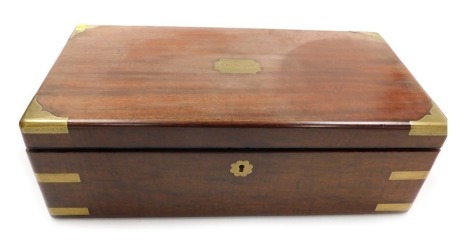 A Victorian mahogany and brass bound writing slope, the lid escutcheon named to I C Forsyth, opening to reveal a tooled leather slope and fitted interior, with two cut glass inkwells, recessed brass carrying handles, 16cm high, 50.5cm wide, 26.5cm deep.