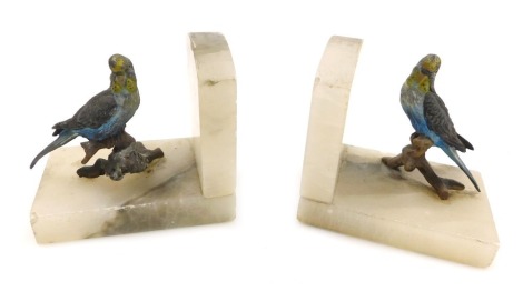 A pair of early 20th cold painted metal and onyx book ends, modelled with a pair of budgerigars, each 11cm wide.