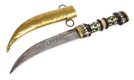 A 20thC Syrian Magdali dagger with a brass capped and inlaid ebony hilt, curved double edge blade and brass scabbard, 38cm long.