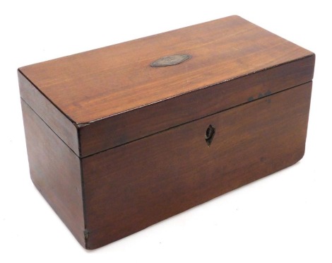 A Georgian mahogany tea caddy of rectangular section, the hinged lid opening to reveal a pair of lidded compartments, flanking a mixing bowl recess, with key, 15cm high, 30.5cm widem 15cm deep.