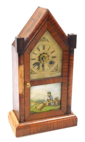 A late 19thC American walnut cased mantel clock, tin dial bearing Roman numerals, eight day movement with coil strike, the case of architectural form, with a double glass panelled door, the lower panel decorated with an alpine scene, raised on a plinth ba