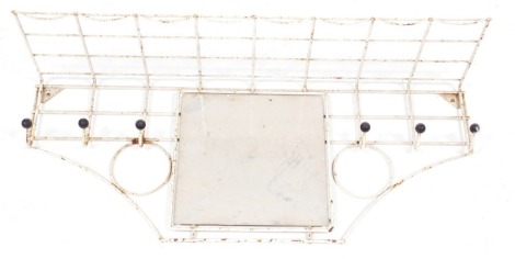 A mid century atomic white cast iron coat rack, wall mounted with central square glass mirror plate, 37cm high, 89cm wide.