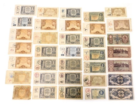 A group of WWII Axis banknotes, for Magyar Nemzeti bank, Budapest, Bankpolski and other Polish banks, all with Third Reich overstamps. (qty).