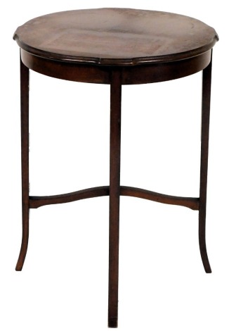 An Edwardian mahogany occasional table, circular top with moulded edge, on plain supports, with splayed feet, x stretcher, 72cm high, 53cm wide.