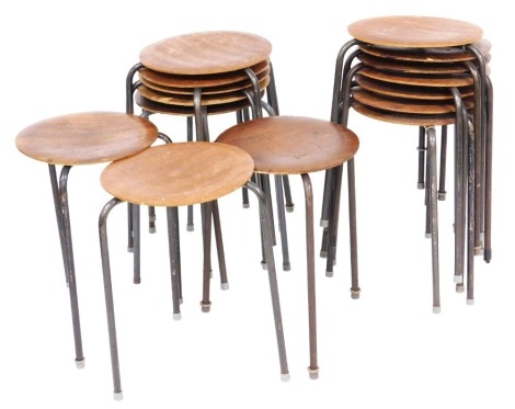 A set of fifteen mid 20thC stools, each with a circular laminate top, on tubular steel legs, 30cm diameter.