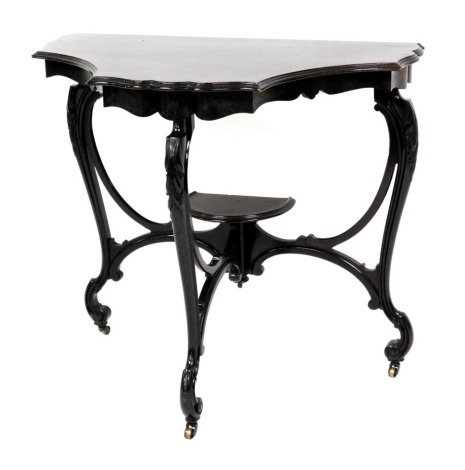 An Edwardian mahogany console table, the shaped top with a moulded edge, on leaf carved cabriole supports with stretchers and castors, constructed from a larger table, 71cm high, 77cm wide.