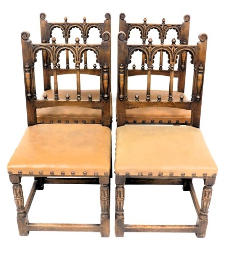 A set of four oak dining chairs, in 16thC style, each back with three arches and turned finials, above a pale brown leather padded seat, on turned fluted legs.