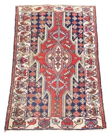 A Persian Kazak style rug, with a design of multicoloured geometric devices, one wide and one narrow border, reduced in size, 12cm x80cm.