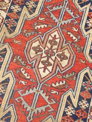 A Persian Kazak style rug, with a design of multicoloured geometric devices, one wide and one narrow border, reduced in size, 12cm x80cm. - 2