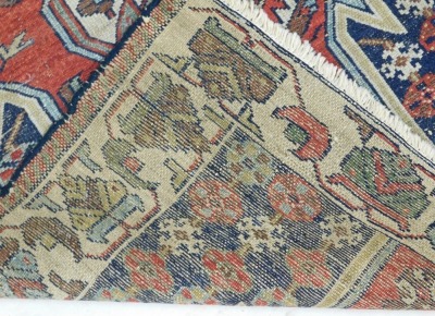 A Persian Kazak style rug, with a design of multicoloured geometric devices, one wide and one narrow border, reduced in size, 12cm x80cm. - 3