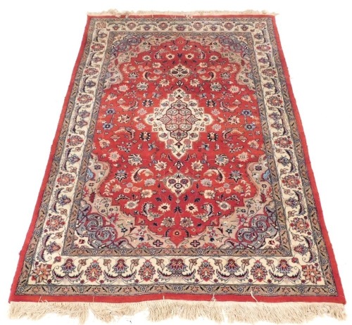 A Persian design rug, with central red ground gul, beige and grey borders, 195cm x 130cm.