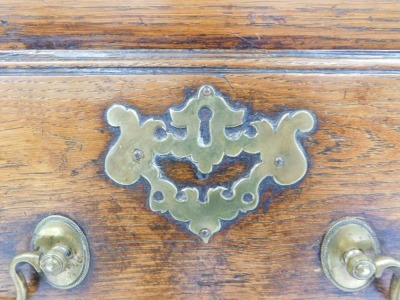 A late 18thC oak dresser, the rectangular top with a raised recess for plates, above three drawers, each with brass drop handles and pierced escutcheons, on square tapering legs, 86cm high, 180cm wide. - 2