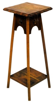 A 1930s oak jardiniere stand.