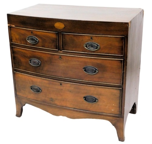 A 19thC mahogany bow fronted chest of drawers, the plain frieze with an oval patera above two short and two long drawers, with oval brass embossed handles, on splayed feet, 86cm high, 86cm wide, 49.5cm deep.