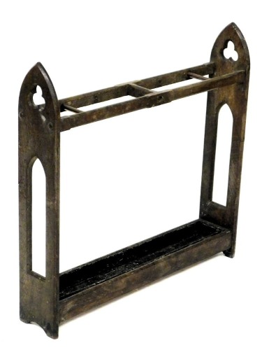 A Victorian Gothic umbrella stand, with three divisions, pierced end supports and metal drip tray, 70cm wide.