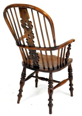 A yew and elm Windsor chair, with a pierced splat, spindle turned rails and a solid seat, on turned legs with H stretcher. - 2