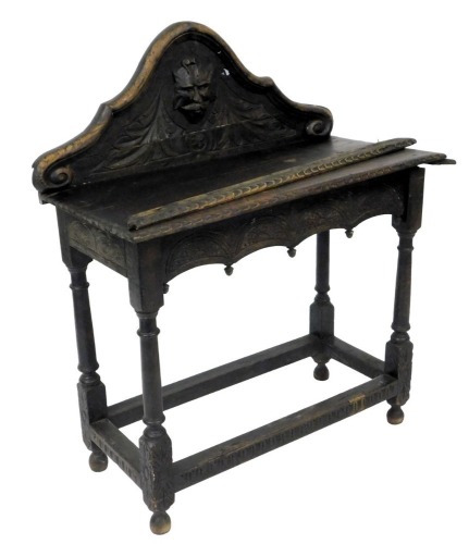 A stained oak and carved hall table, with galleried back, raised on turned supports joined by a stretchers, drawer to one end. (AF)