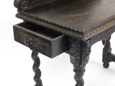 A late Victorian oak side table, the raised back carved with a mask, over a rectangular top with stepped edge, above an arched under tier, on spirally turned supports, 90cm high, 101cm wide, 47cm deep. - 3