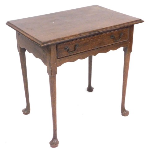 An early 19thC and later oak side table, the moulded top raised above a frieze drawer, on turned legs, terminating in pad feet, 72cm high, 71cm wide, 48cm deep.