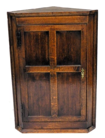 A late 18th/early 19thC hanging corner cabinet, single panelled door, iron H hinges, 105cm high, 70cm wide.