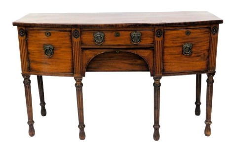 Early 19thC mahogany bow fronted sideboard, with a central drawer, flanked by a deep drawer and further drawer, each with cast brass leaf and shell handles, with a further central drawer to the apron, on turned carved and fluted legs, 93cm high, 151cm wid