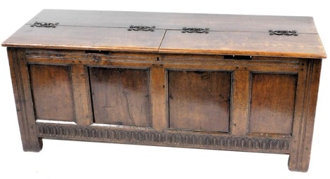 An oak and pine coffer, with a quadruple panelled front, on stiles, 69cm high, 185cm wide. (AF)