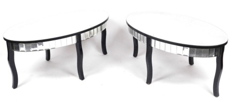 A pair of modern glass and ebonised coffee tables, each with an oval top above a glass panelled frieze, raised on four cabriole legs, 46cm high, 100cm wide, 60cm deep. (one, AF)