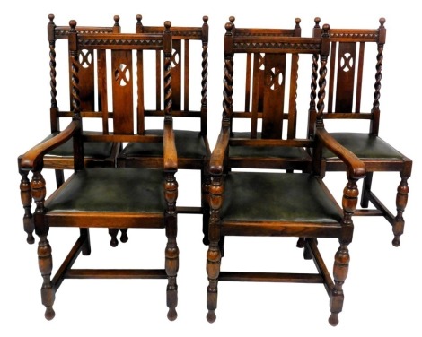 A set of six early 20thC oak dining chairs, with green leatherette drop in seats, raised on cup and cover supports, united by a H frame stretcher, comprising a pair of carvers and four single chairs.