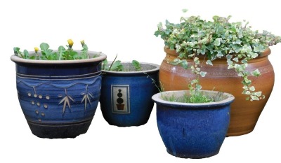 A stoneware garden planter, with scrolling patera border, 35cm high, 50cm diameter, and three further garden pots, each with blue glaze. (4)