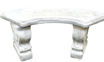 A concrete garden seat, with a curved top, raised on scroll ends, 102cm wide.