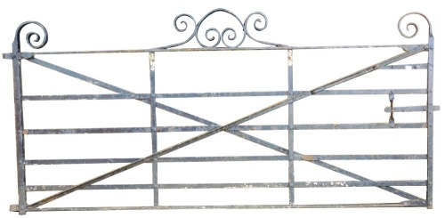 A large cast and wrought iron garden gate, 277cm wide, 130cm high.