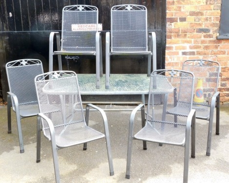 A rectangular garden table, with glass top and metal frame, together with six metal framed garden chairs.