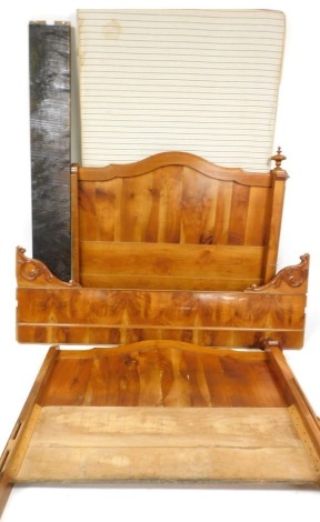 A French yew wood bed, with foliate carved sides, and a fabric covered hard bed base.