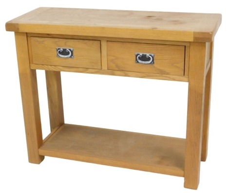 A light oak side table, with two frieze drawers, on plain legs with under tier, 105cm wide.