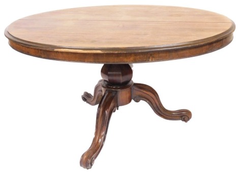 An early Victorian rosewood breakfast table, with moulded oval top, octagonal baluster pillar, on three carved and channelled scroll legs with brass castors, approx. 76cm high, 132cm wide, 106cm deep, floor to base of table approx. 71cm.