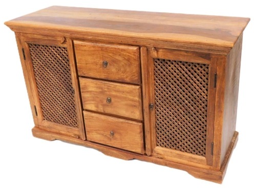 A hardwood sideboard, with an arrangement of three drawers flanked by two doors with slatted grills, on a plinth, 82cm high, 136cm wide.