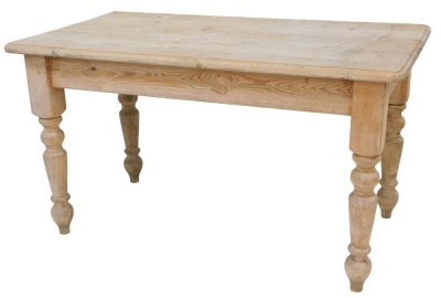 A pine kitchen table, the rectangular top with a moulded edge, on turned legs, 77cm high, the top 136cm x 76cm.