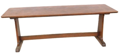 An oak refectory table, the rectangular top with canted corners, on a trestle base with end supports, 76cm high, 213cm wide, 67cm deep.