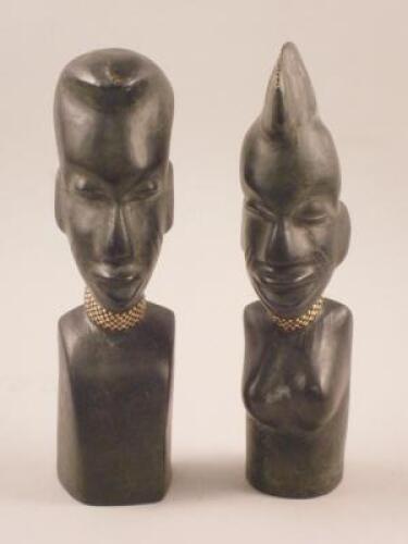 A pair of African leather and terracotta busts