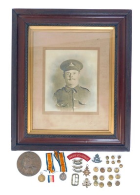 Three World War I medals, named to Private AE Jones, South Staffordshire Regiment, 14787, comprising War Medal, Victory Medal, and 1914-15 Star, together with widow's penny, in case, cloth badges, military buttons, cap badges, etc., together with...