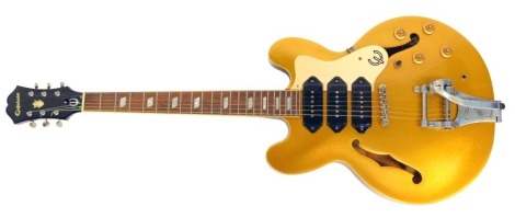 An Epiphone Riviera P93 MG electric guitar, serial number 11021502198, the body in gold coloured casing, 105cm long, in hard case.