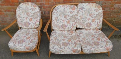 An Ercol elm framed suite, comprising two seater sofa and armchair, model number 203, with removable back and seat cushions, decorated with flowering plants, Asiatic pheasants, etc., in purples, yellows and greens, against an off white ground,... - 2