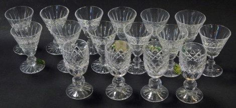 A set of twelve Waterford crystal Tramore cordial glasses, some with paper labels, each stamped, 7cm high, together with a set of four Waterford Donegal pattern liqueur glasses, 8.5cm high.