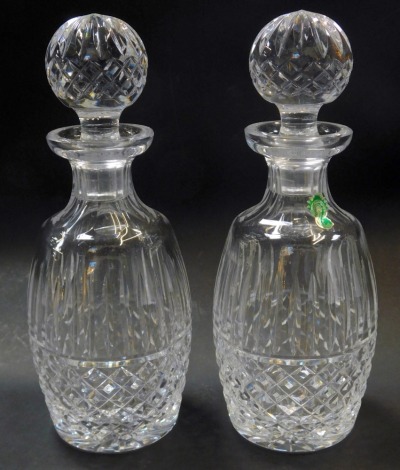 A pair of Waterford crystal Tramore pattern decanters and stoppers, one with paper label, each 27cm high.