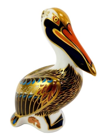 A Royal Crown Derby porcelain brown pelican paperweight, red printed marks and gold stopper, 14cm high, boxed.