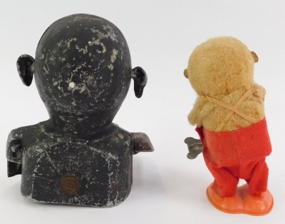 A 20thC Hong Kong clockwork windup toy, modelled as a monkey, impressed mark to underside, Made in Hong Kong, 14cm high (AF), together with a cast metal money box, modelled as a gentleman wearing a red jacket, 17cm high.These items are listed on the basis - 2